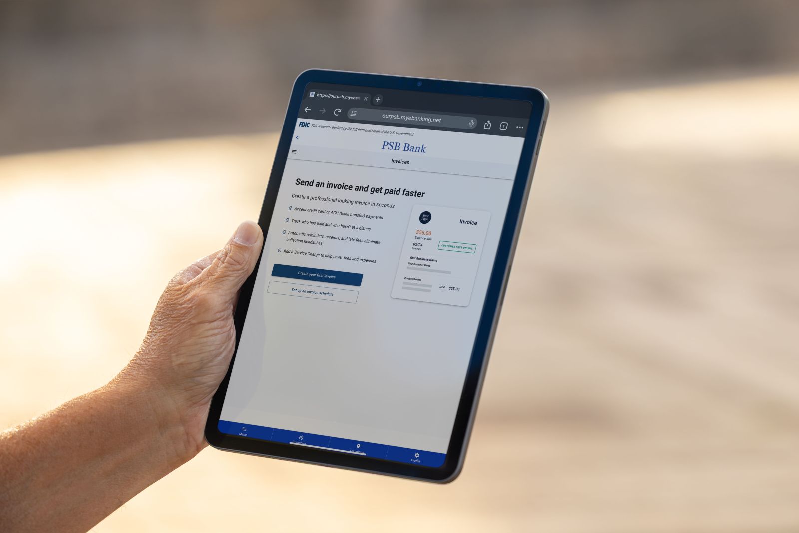Hand holding a tablet displaying PSB Bank&rsquo;s Autobooks invoicing platform with options to create and send customer invoices.