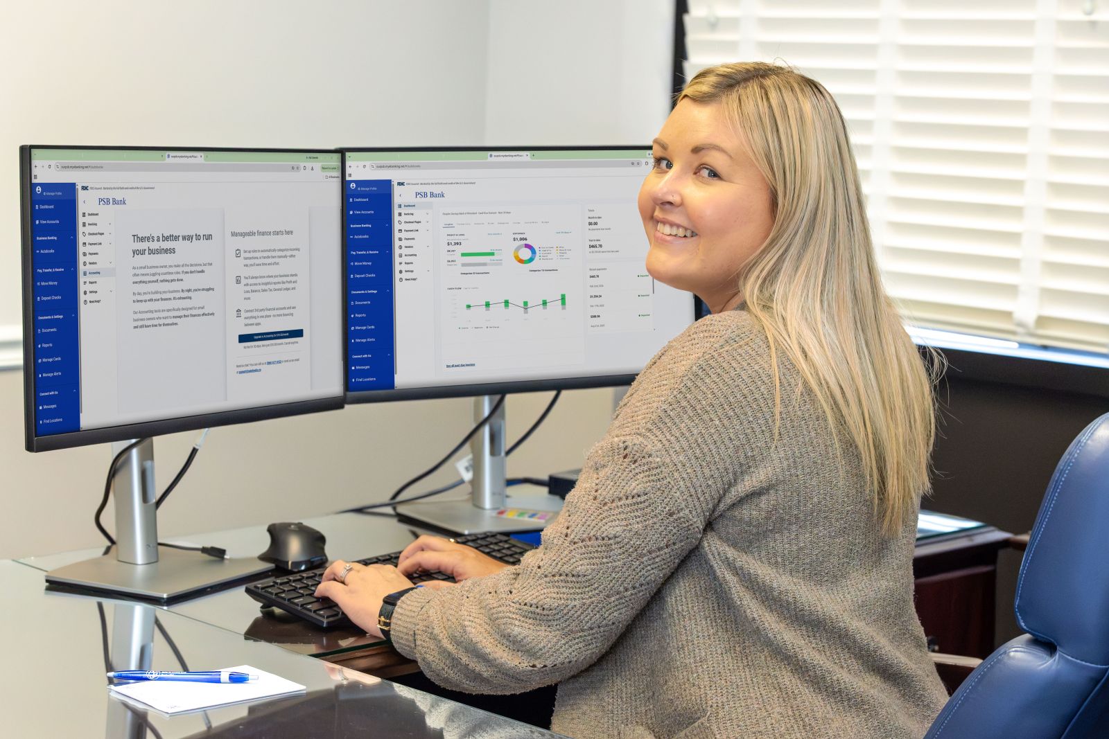 PSB Bank employee using dual monitors to manage business banking finances through PSB Bank&rsquo;s online banking platform.