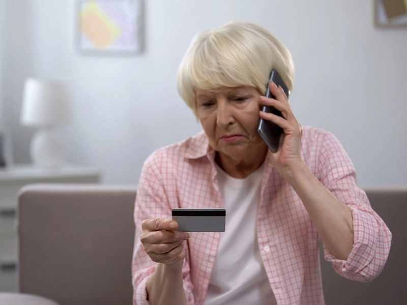 woman calling holding credit card